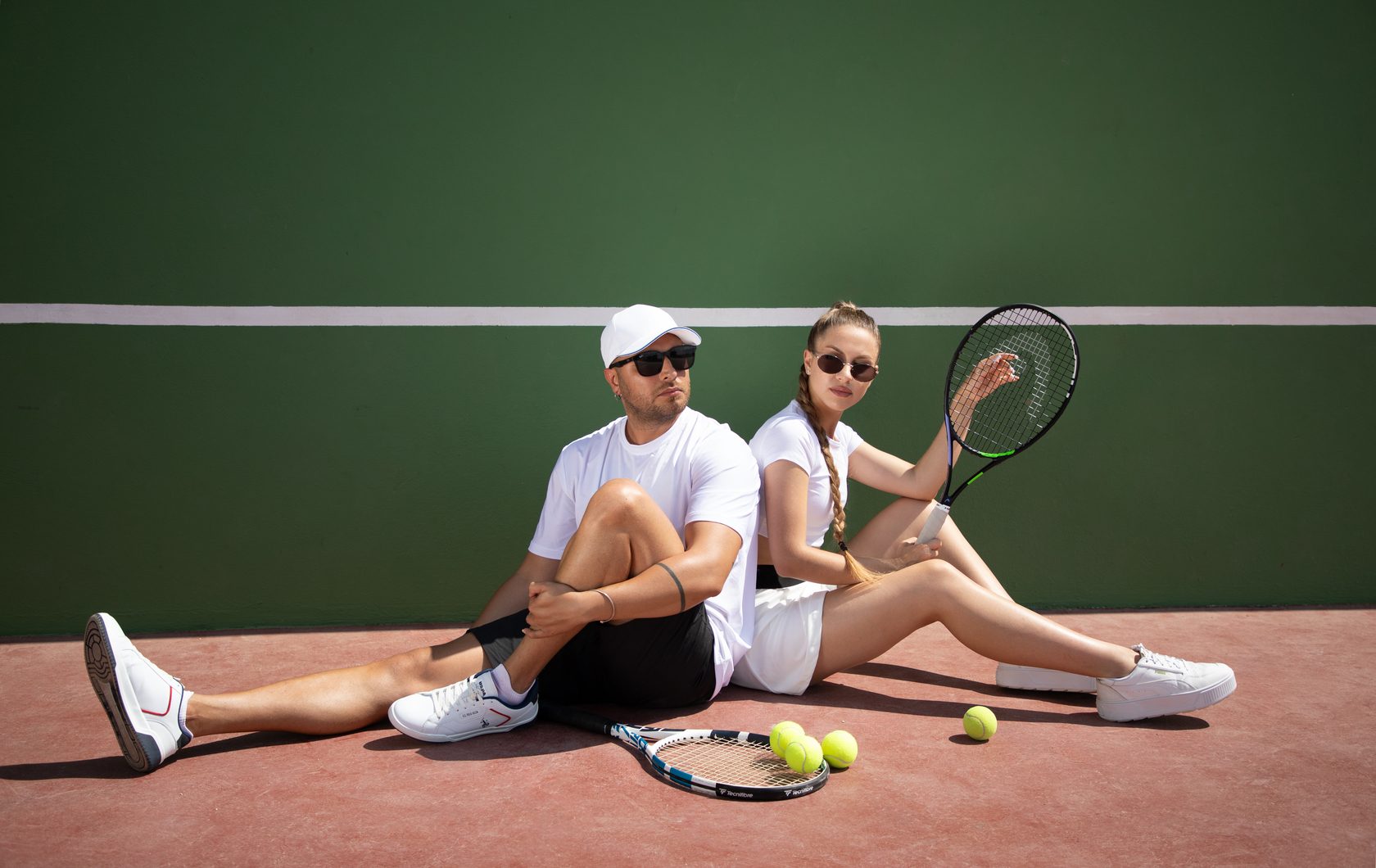 Two players resting on a tennis court